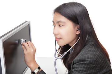 Image showing Businesswoman examining PC screen w stethoscope
