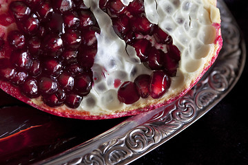 Image showing Sliced Pomegranate with arils on silver plate