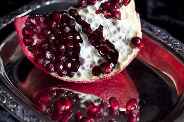 Image showing Sliced Pomegranate with arils on silver plate