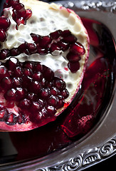 Image showing Sliced Pomegranate with arils on silver plate