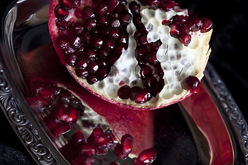 Image showing Sliced Pomegranate with arils on silver plate