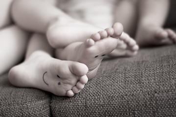 Image showing Little childrens feet while relaxing on couch