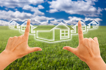 Image showing Female Hands Framing Houses Over Grass and Sky