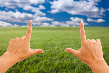 Image showing Female Hands Making a Frame Over Grass and Sky