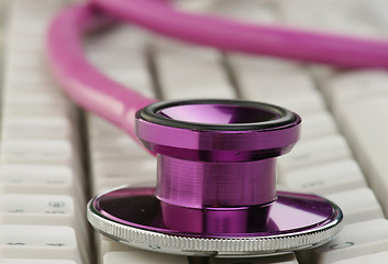 Image showing pink stethoscope on keyboard