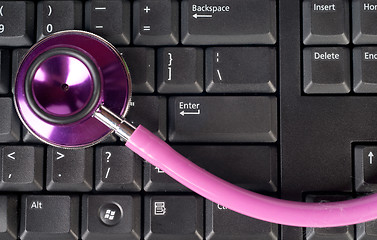 Image showing pink stethoscope on keyboard