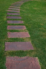 Image showing Tilled footpath on the green lawn.