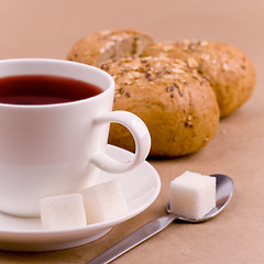 Image showing cup of tea, sugar and bread