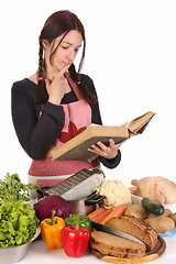Image showing housewife thinking with a book recipe