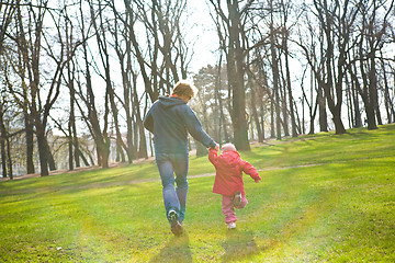 Image showing Father and daughter running