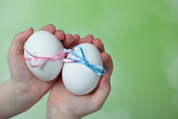 Image showing Children hands holding  Easter Eggs