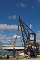 Image showing People putting boat into water