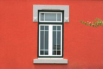 Image showing window in red wall