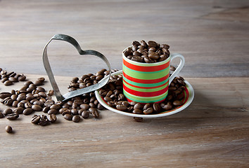 Image showing Coffee beans in striped cup