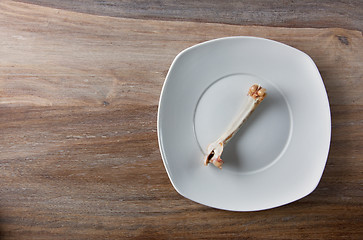 Image showing Empty dinner plate with bones