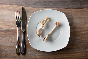 Image showing Empty dinner plate with bones