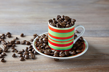 Image showing Coffee beans in striped cup