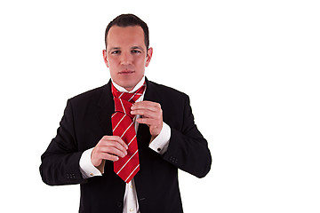 Image showing Businessman putting on tie