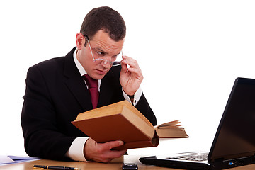 Image showing businessman on desk reading and studying