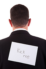 Image showing back of businessman, with kick me written in a paper 