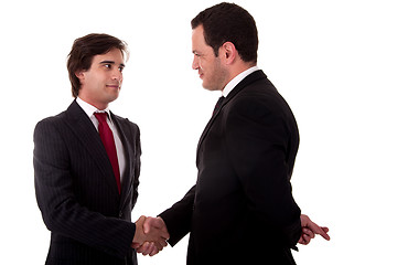 Image showing two businessmen shaking hands, and one businessman with his fingers crossed behind his back and smiling