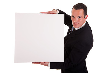 Image showing Businessman holding a white board, looking to camera