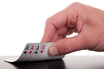 Image showing man's hand revealing four aces