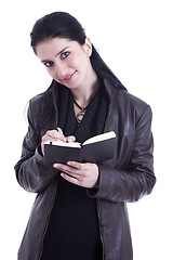 Image showing beautiful businesswoman taking notes