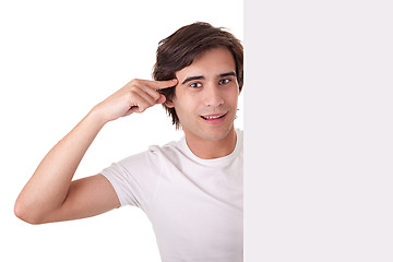 Image showing Young man holding a blank billboard,gesturing have an ideia