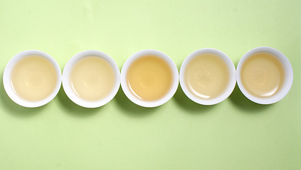 Image showing tea in cup in a row