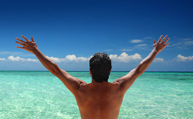 Image showing Man standing looking at ocean