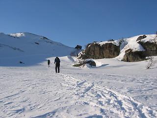 Image showing Two men skiing in mountains