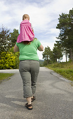 Image showing Obese mother carrying child