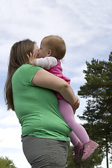 Image showing Kissing obese mother