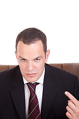 Image showing Businessman upset seated on a chair, isolated on white background. Studio shot.