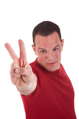 Image showing man with arm raised in victory sign, isolated on white background. Studio shot