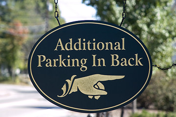 Image showing Wooden hand sign pointing to additional parking