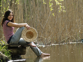 Image showing Girl resting near lake