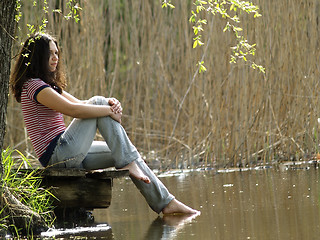 Image showing Girl resting near lake