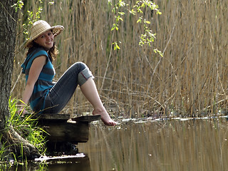 Image showing Girl resting near lake