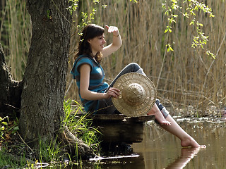 Image showing Girl resting near lake