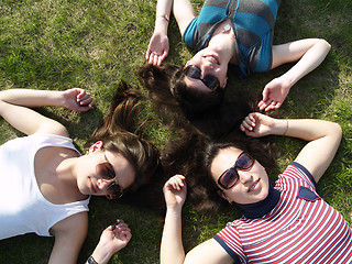 Image showing Girls laying on grass