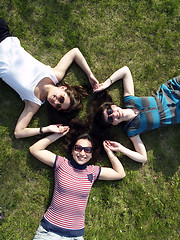 Image showing Girls laying on grass