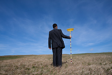 Image showing businessman cleaning the environment