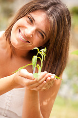 Image showing woman holding a plant