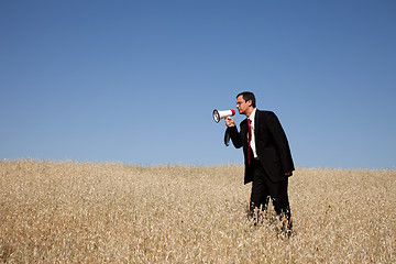 Image showing Businessman shouting at the megaphone to you