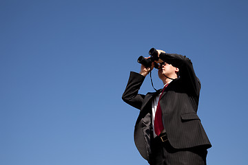 Image showing Businessman looking through binoculars