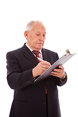 Image showing senior businessman writing