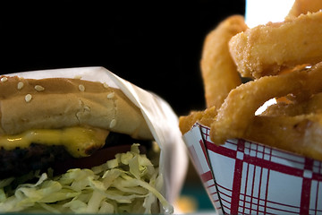 Image showing Close up on Onion Rings and a Hamburger