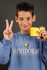 Image showing A young boy with a disposable camera